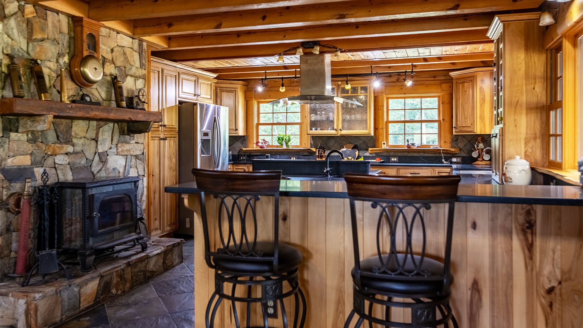 cozy kitchen with woodstove in log home at Virginia horse farm