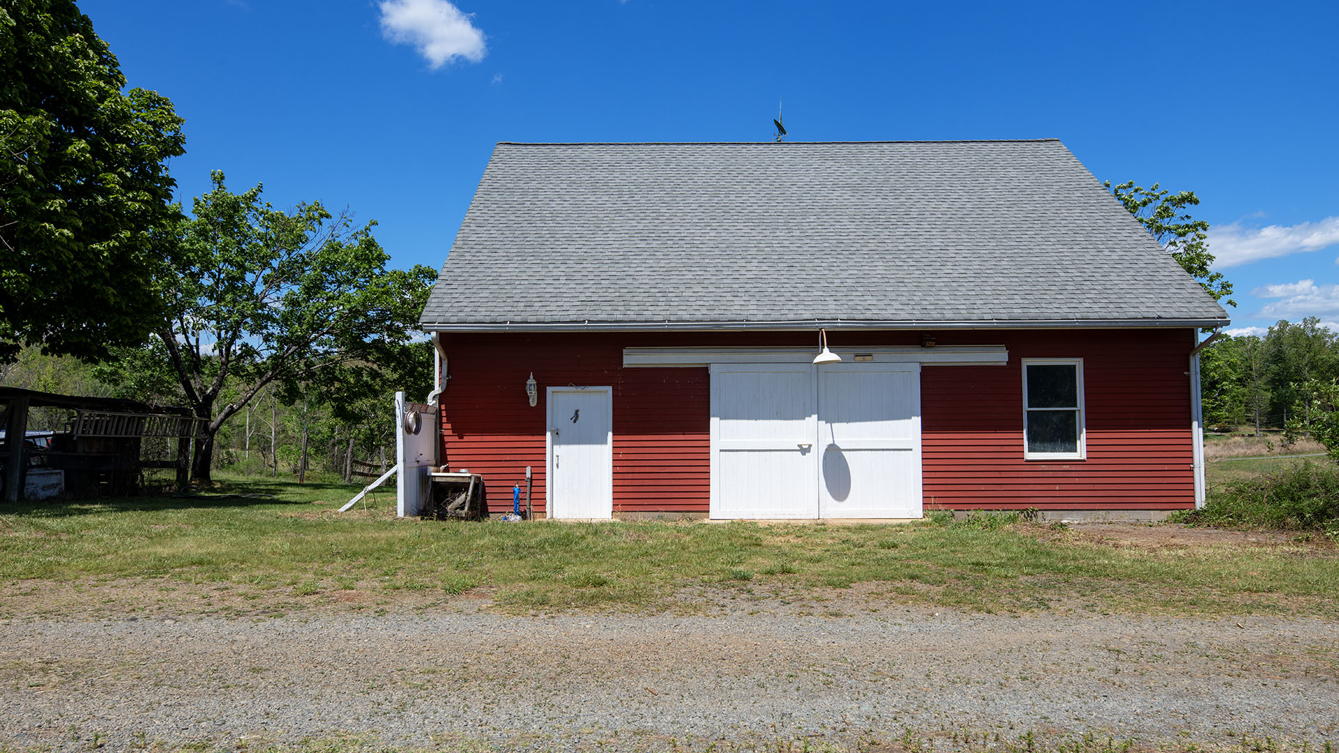 Classic red agricultural barn at Asgardd Farm in Afton VA with white sliding doors