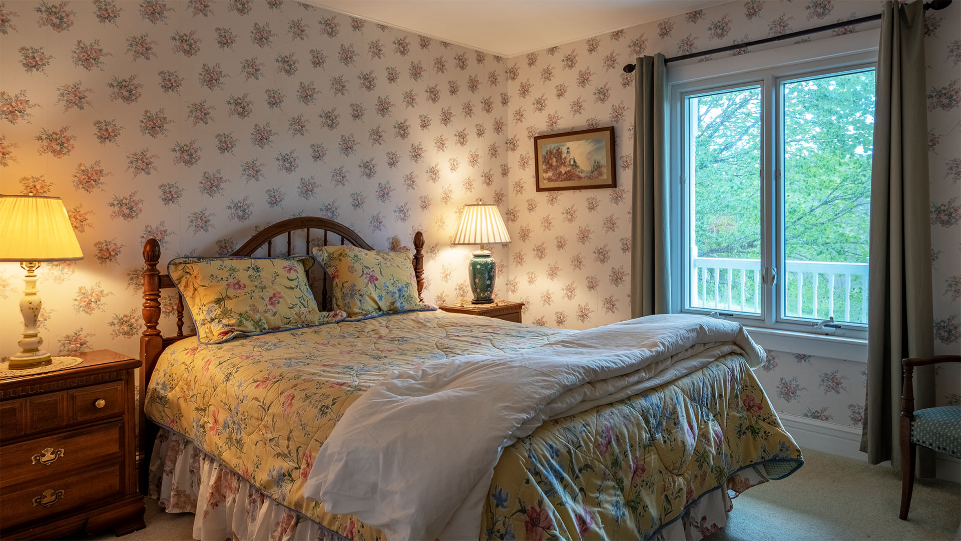 Bedroom at Asgardd Farm in Albemarle County with floral wallpaper and window overlooking the property