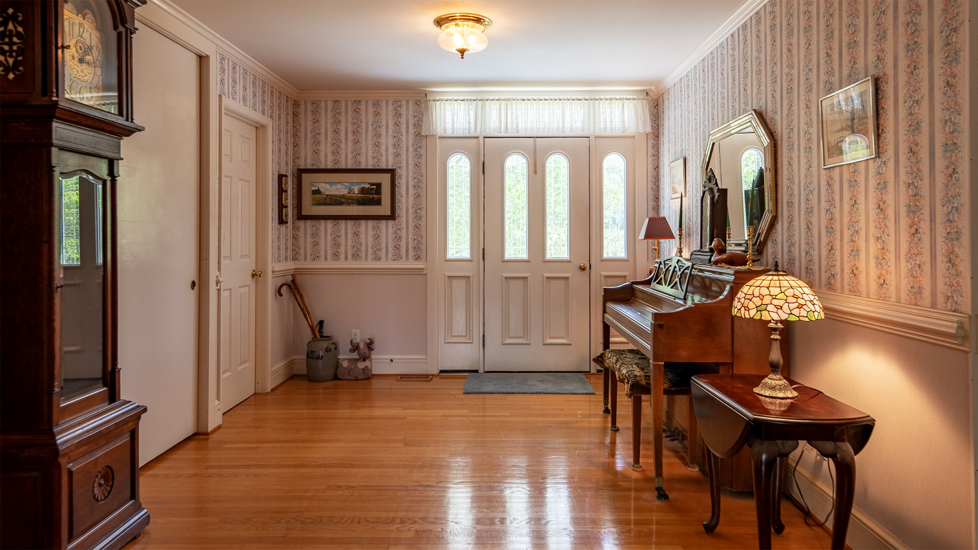 Farmhouse foyer entry at Asgardd Farm in Afton VA with red front door and natural light
