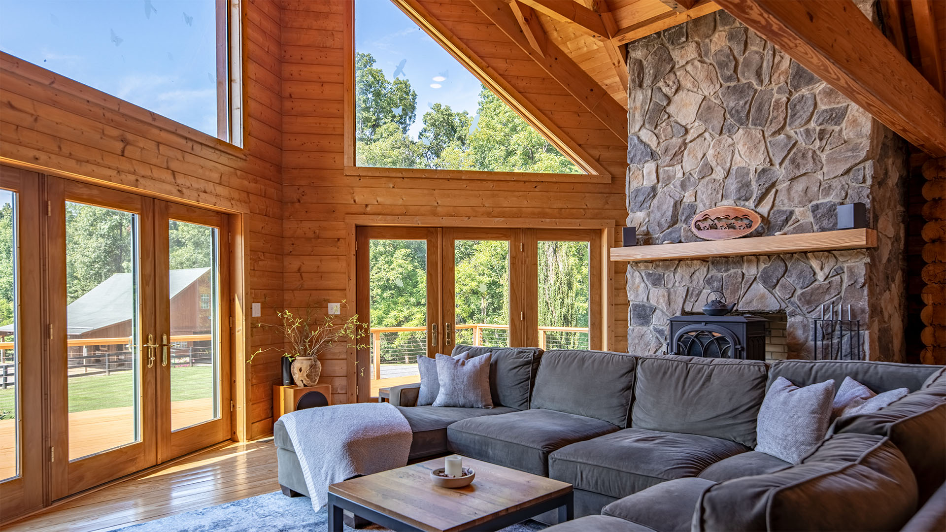 Great room with stone fireplace in the Madison Virginia log home