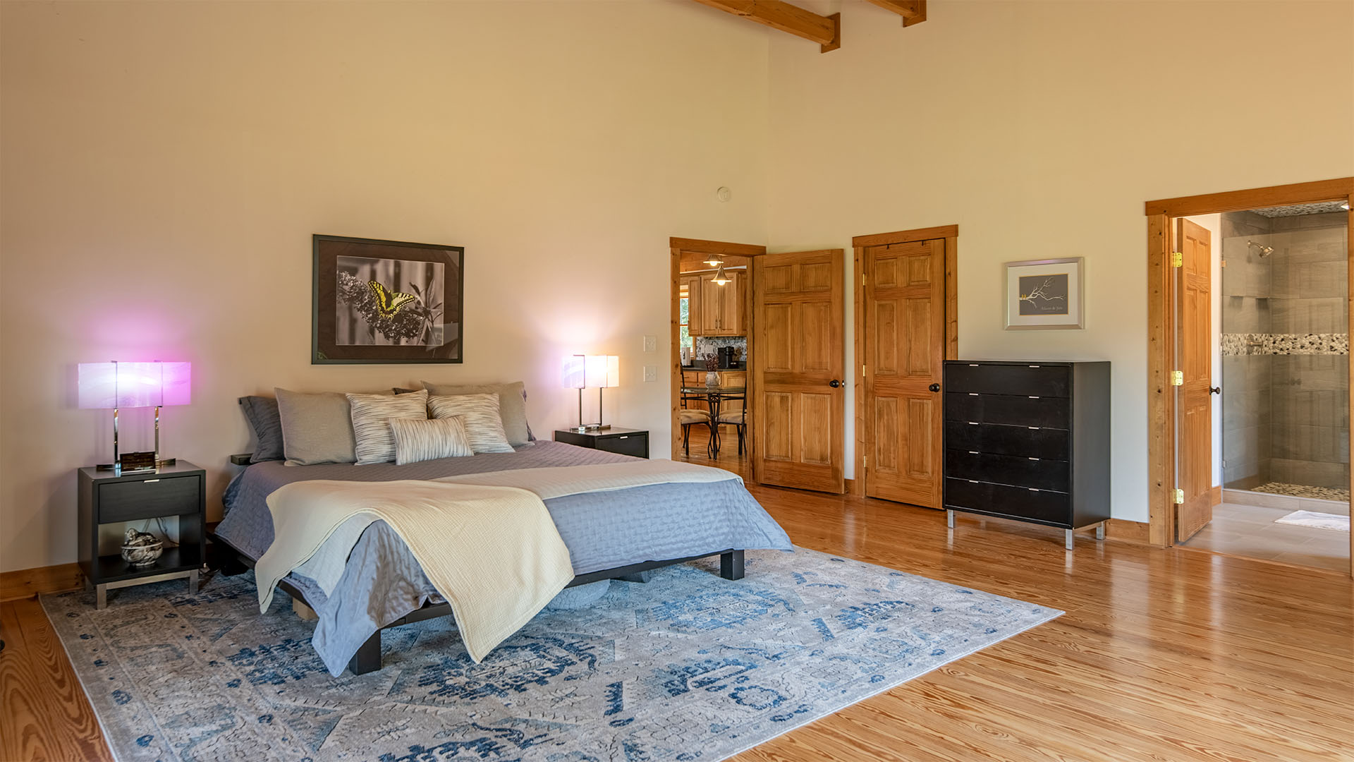 Main-level primary bedroom in the log home on 44 acres in Madison Virginia