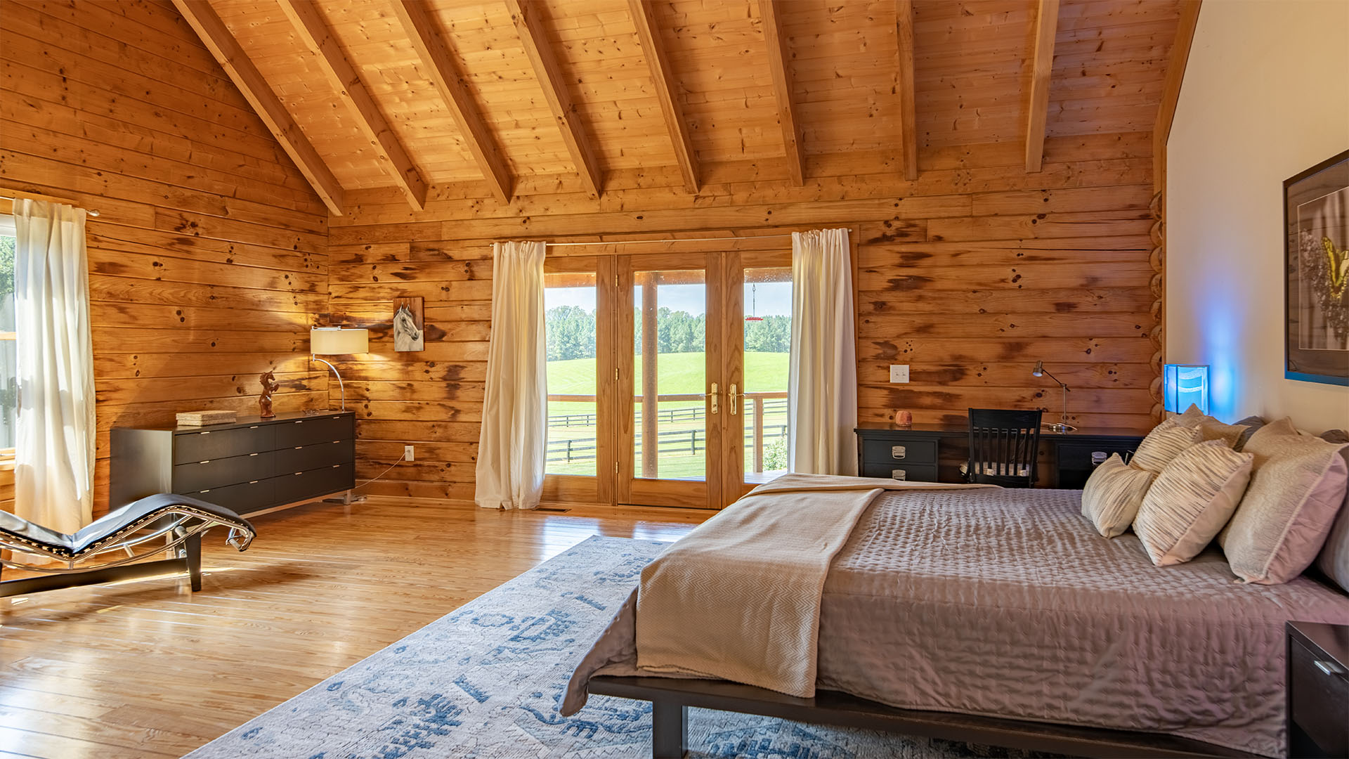 Primary bedroom in the log home at the 44-acre Madison Virginia farm